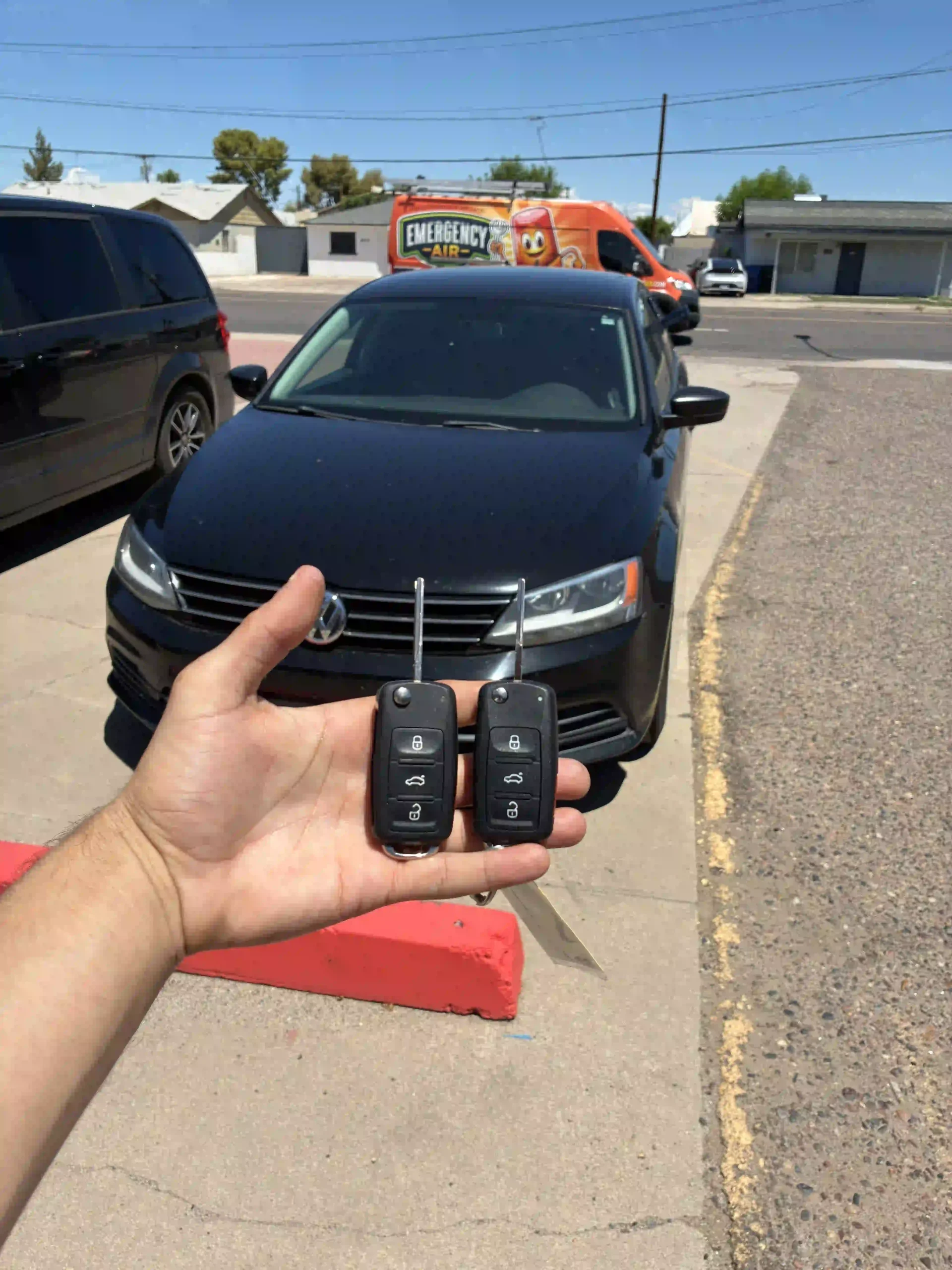 Technician unlocking a sedan with professional Locksmith Services in Tempe after keys were locked inside the vehicle